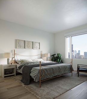 Chicago apartment for rent - A bedroom with a large bed and a view of the city at Windsor North + Vine 633 W North Ave, Chicago, IL 60610.