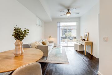Kirkland apartment for rent - a living room with a couch and a table and a ceiling fan
