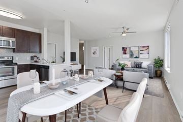 Oakland apartment for rent - a living room and dining room with a white table and chairs