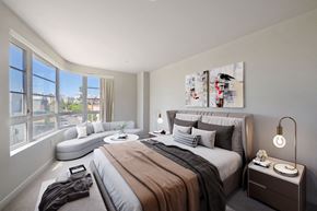 Los Angeles apartment for rent - a bedroom with a bed and a couch and a large window