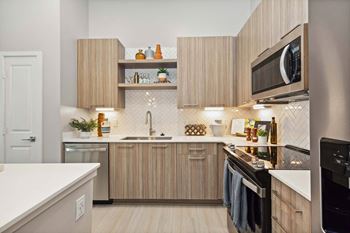 European-style cabinets in a veranda teak finish with dimmable undercabinet lighting