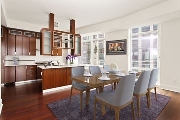 New York apartment for rent - A modern kitchen with a dining table set for four.