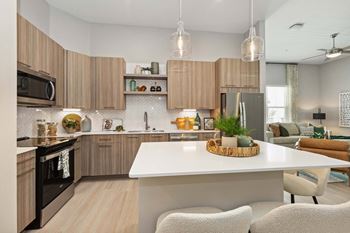 White quartz countertops with herringbone tile backsplash