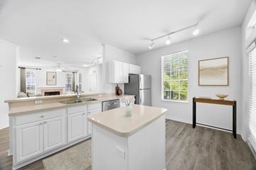 Tampa apartment for rent - A kitchen with white cabinets and a large island.