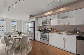 Seattle apartment for rent - A modern kitchen with a dining table and chairs.
