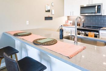 Fitted kitchen with island dining