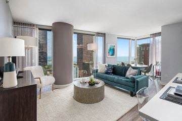 Chicago apartment for rent - a living room with a turquoise couch and a table