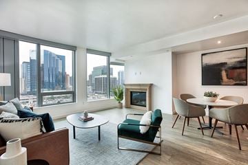 Bellevue apartment for rent - a living room with a large window and a table and chairs
