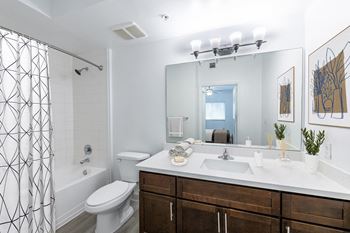 Spacious bathrooms with granite countertops and ample storage