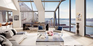 New York apartment for rent - a living room with a view of the water and a couch and tables