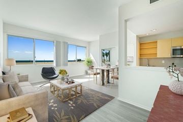 Santa Monica apartment for rent - a living room with a couch and a table    and a dining room