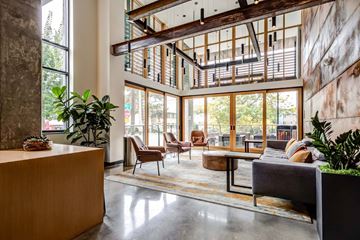 Seattle apartment for rent - the living room of a condo with large windows and furniture