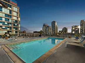 Los Angeles apartment for rent - a pool with a city skyline in the background at night
