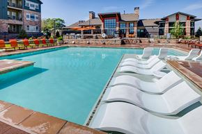 Lakewood apartment for rent - Pool with in water lounge chairs at Windsor at Pinehurst, Lakewood, Colorado