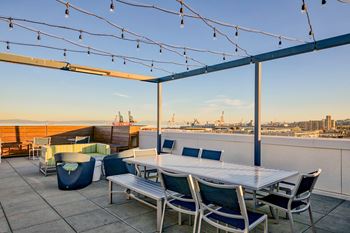 Rooftop deck with bay and city views, cabanas, lounging and dining spaces and barbecue grill
