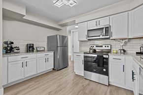 Southfield apartment for rent - A modern kitchen with white cabinets and stainless steel appliances.