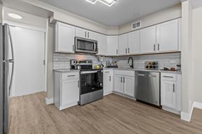 Southfield apartment for rent - A kitchen with white cabinets and stainless steel appliances.