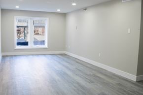 Aurora apartment for rent - A spacious room with a large window and grey flooring.