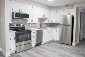 Aurora apartment for rent - A kitchen with white cabinets and stainless steel appliances.