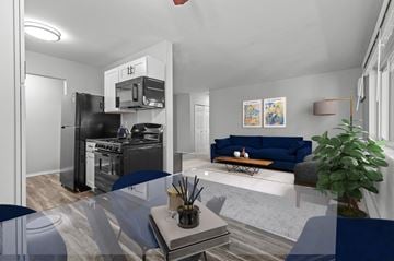 Ypsilanti apartment for rent - A modern kitchen with a blue sofa in the living room.