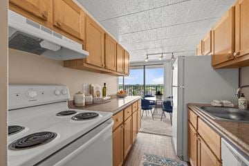 Southfield apartment for rent - A kitchen with a white stove and wooden cabinets.
