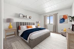 Southfield apartment for rent - A bedroom with a large bed and a window with curtains.