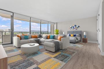 Southfield apartment for rent - A modern living room with a large grey sofa and a coffee table.