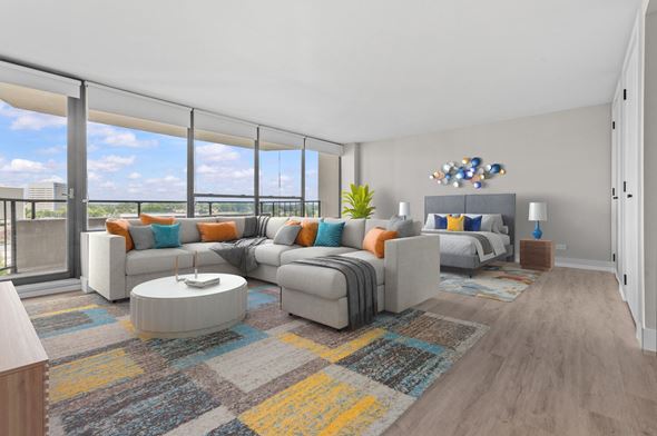 Southfield apartment for rent - A modern living room with a large grey sofa and a coffee table.