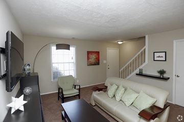 Indianapolis apartment for rent - A living room with a white couch and a black coffee table.