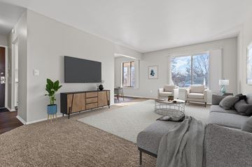 Southfield apartment for rent - A living room with a grey couch and a television on the wall.