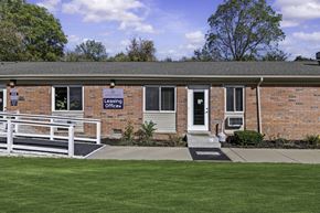 Ypsilanti apartment for rent - A brick building with a sign that says "Lending Office" on it.