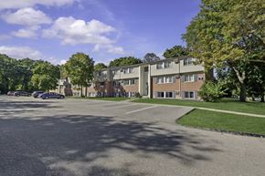 Ypsilanti apartment for rent - A parking lot in front of a residential building.