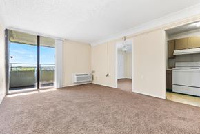Memphis apartment for rent - A spacious living room with a sliding glass door leading to a balcony.