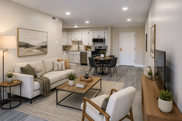 Aurora apartment for rent - A modern living room with a white couch, a glass coffee table, and a painting on the wall.