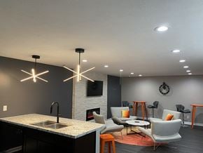 Indianapolis apartment for rent - A modern kitchen with a black countertop and a fireplace.