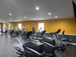 Indianapolis apartment for rent - A gym with exercise equipment and a TV.