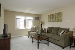 Urbana apartment for rent - A living room with a couch, chair, and television.