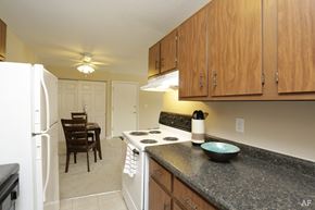 Urbana apartment for rent - A kitchen with a black counter top and wooden cabinets.