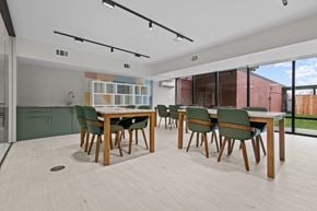 Southfield apartment for rent - A modern dining room with a wooden table and chairs.