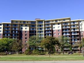 Southfield apartment for rent - A large apartment building with a green lawn in front.