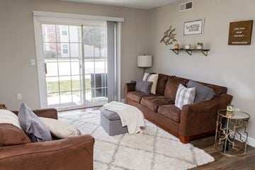 Urbana apartment for rent - A living room with a brown couch and a white rug.