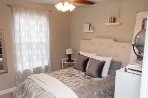 Urbana apartment for rent - A bedroom with a bed, nightstand, and a ceiling fan.