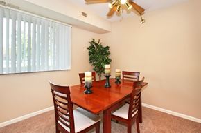 Cuyahoga Falls apartment for rent - A dining room with a wooden table and chairs.