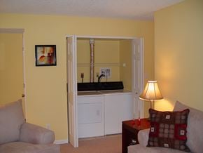 Decatur apartment for rent - A living room with a grey couch, a brown pillow and a lamp.