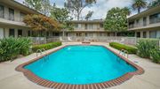 Pasadena apartment for rent - A swimming pool surrounded by a brick border in a residential area.