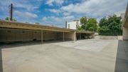 Pasadena apartment for rent - A parking lot with a building in the background and numbered parking spaces.