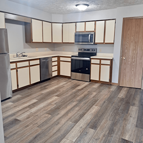 Kearney apartment for rent - an empty kitchen with wood flooring in an apartment