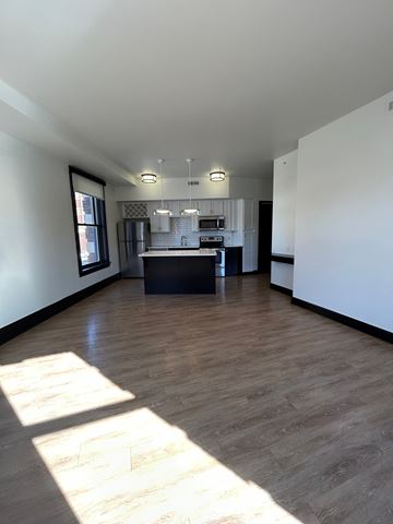 Omaha apartment for rent - A kitchen area with a counter and a fridge.