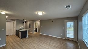 North Platte apartment for rent - A spacious room with a kitchenette and a view.