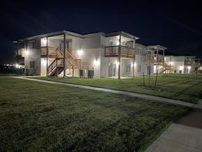 North Platte apartment for rent - a large white house at night with a yard and stairs